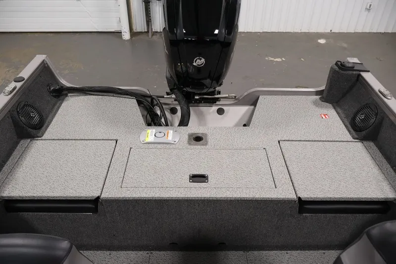 Slide: The Image of 2026 Crestliner 1650 Hawk WT boat interior with motor, featuring storage compartments and speakers. - 38