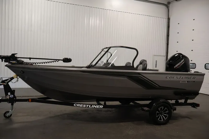 Slide: The Image of 2026 Crestliner 1650 Hawk WT fishing boat in showroom, side view. - 20