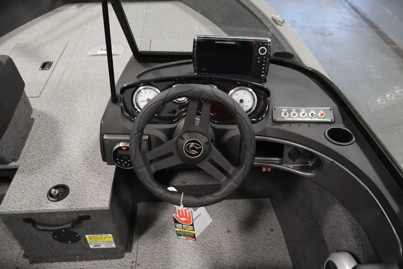 Slide: The Image of 2026 Crestliner 1650 Hawk WT boat dashboard with steering wheel and electronic controls. - 40