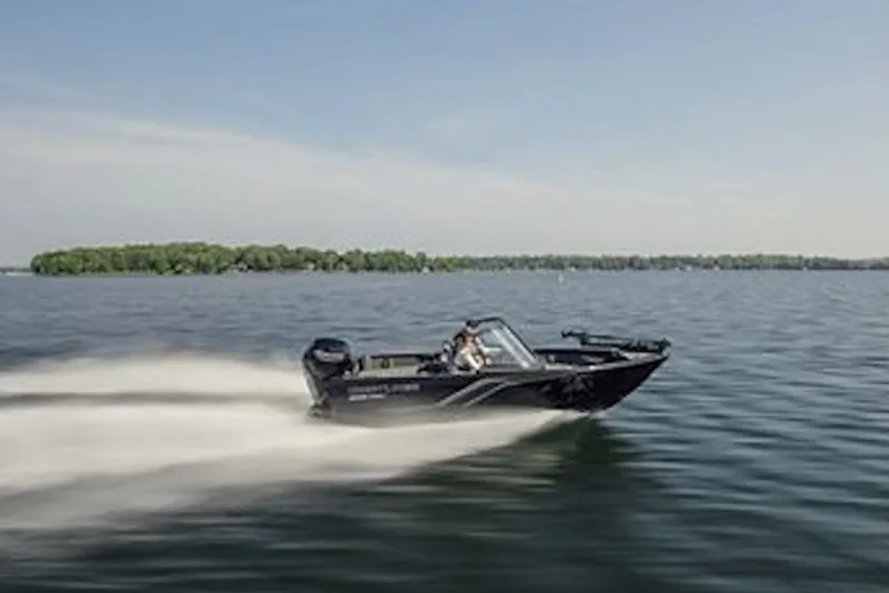 Slide: The Image of 2026 Crestliner 1650 Hawk WT speeding on a lake with distant shoreline. - 57