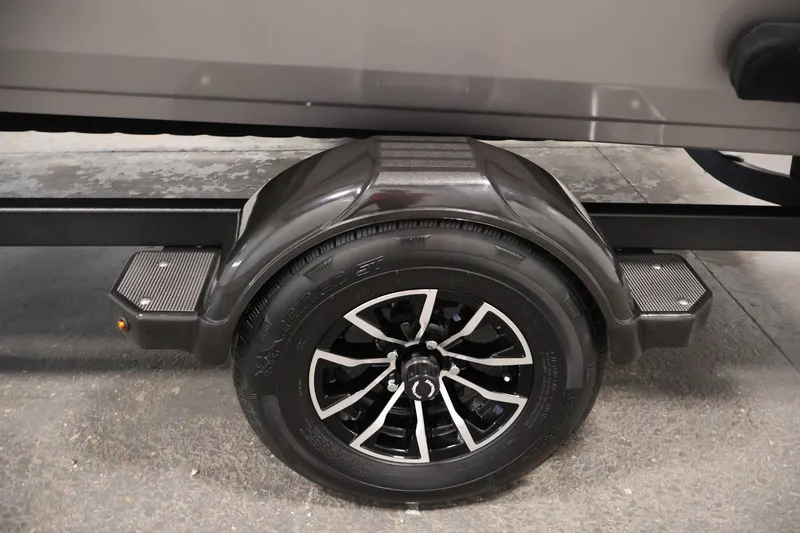 Slide: The Image of Trailer wheel of 2026 Crestliner 1650 Hawk WT boat, featuring sleek black alloy rims. - 50