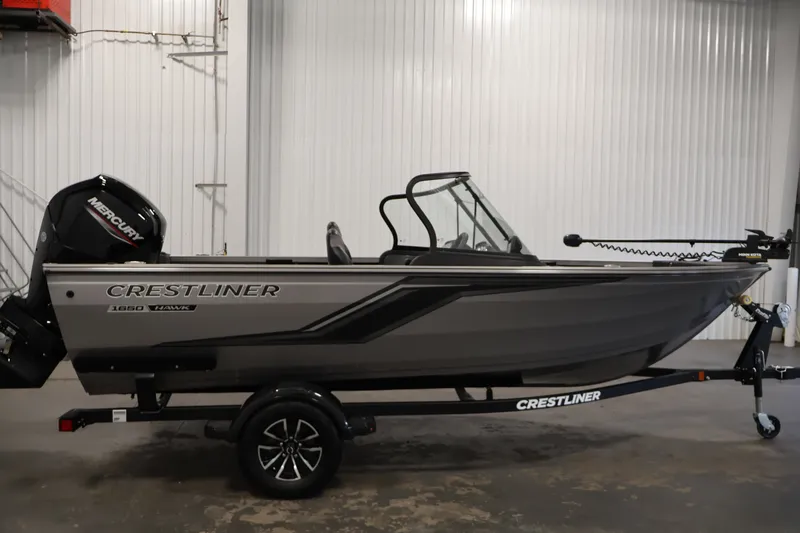 Slide: The Image of 2026 Crestliner 1650 Hawk WT fishing boat in a showroom, side view. - 12