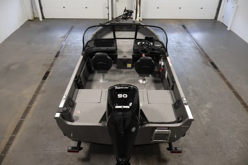 Slide: The Image of 2026 Crestliner 1650 Hawk WT boat in a garage, featuring a Mercury 90 engine. - 18