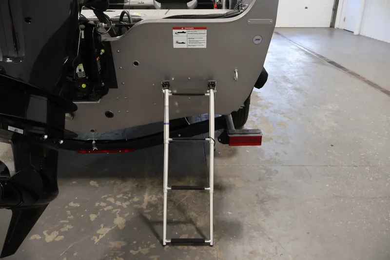Slide: The Image of Rear view of 2026 Crestliner 1650 Hawk WT boat with ladder extended. - 43