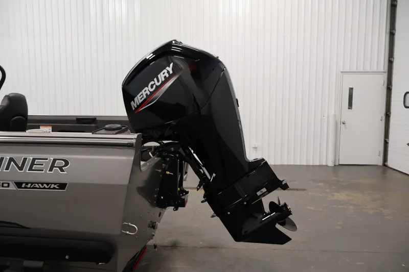 Slide: The Image of 2026 Crestliner 1650 Hawk WT boat with Mercury outboard motor in a garage setting. - 45
