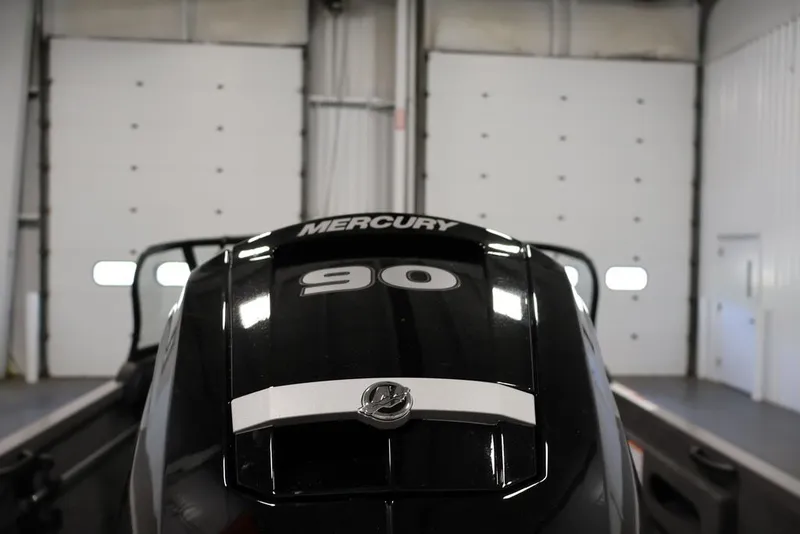 Slide: The Image of 2026 Crestliner 1650 Hawk WT with Mercury 90 engine in a garage setting. - 47