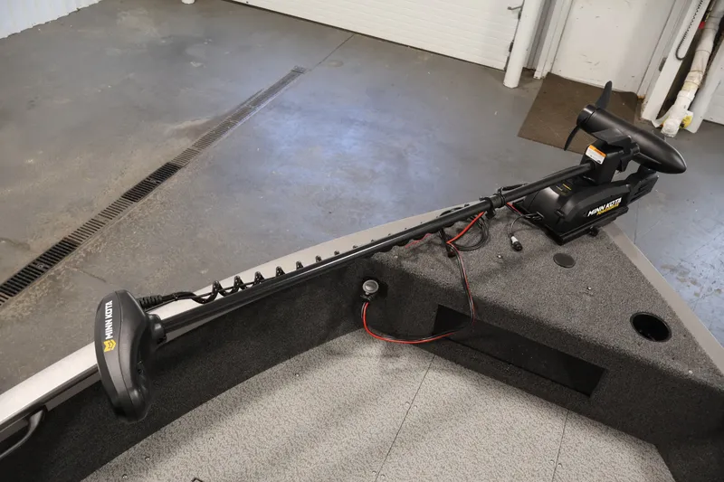 Slide: The Image of 2026 Crestliner 1650 Hawk WT boat with Minn Kota trolling motor in a garage setting. - 19