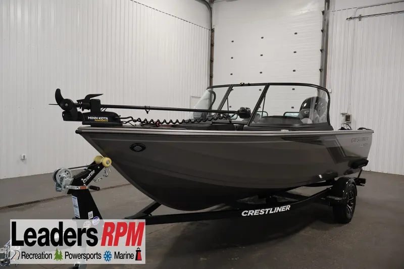The Image of 2026 Crestliner 1650 Hawk WT boat on trailer in indoor showroom. - 9