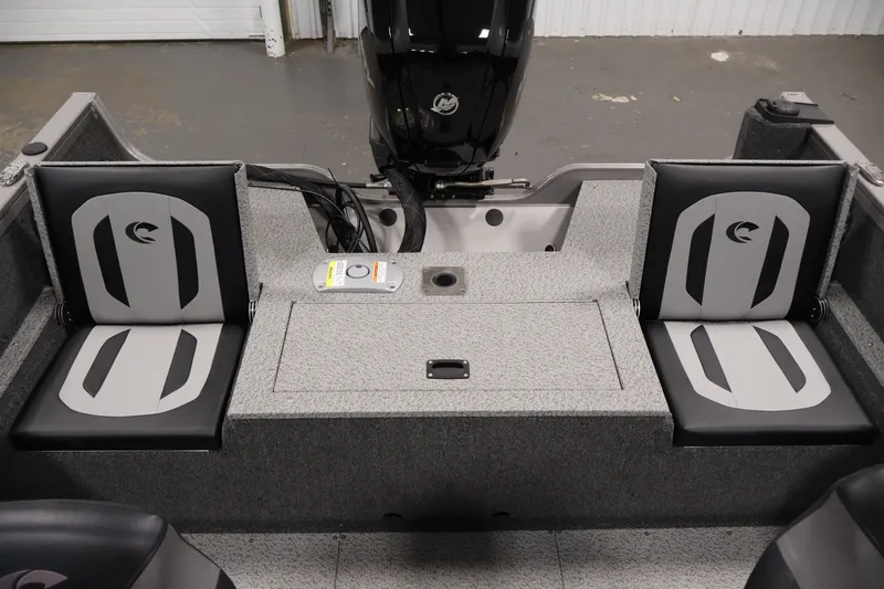 Slide: The Image of 2026 Crestliner 1650 Hawk WT boat interior with dual cushioned seats and motor. - 41