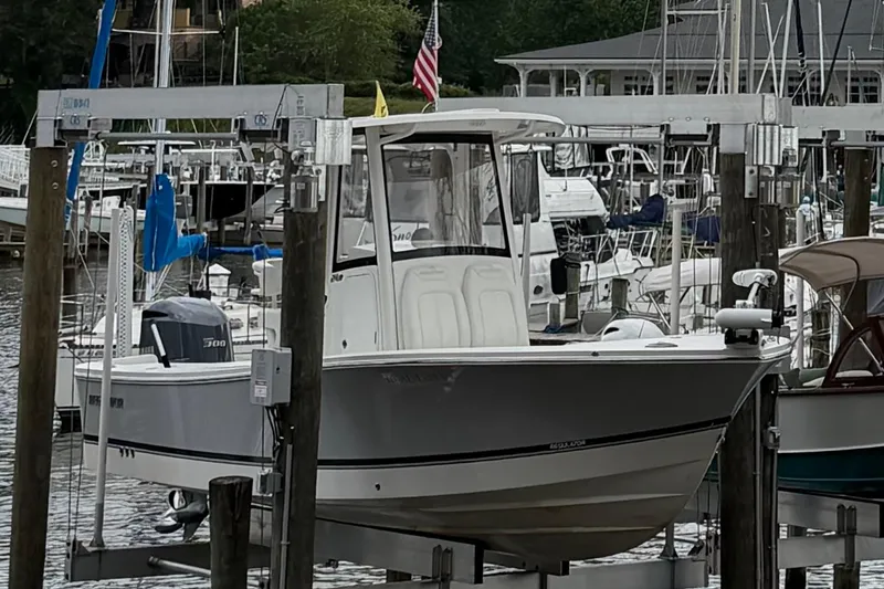The Image of 2020 Regulator 24XO boat docked at a marina with surrounding vessels. - 0