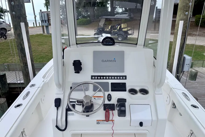 Slide: The Image of 2020 Regulator 24XO boat console with Garmin navigation, steering wheel, and controls. - 3