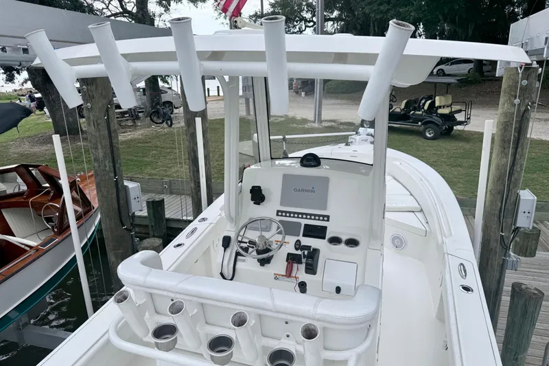 Slide: The Image of 2020 Regulator 24XO boat with Garmin navigation, docked at a marina. - 6