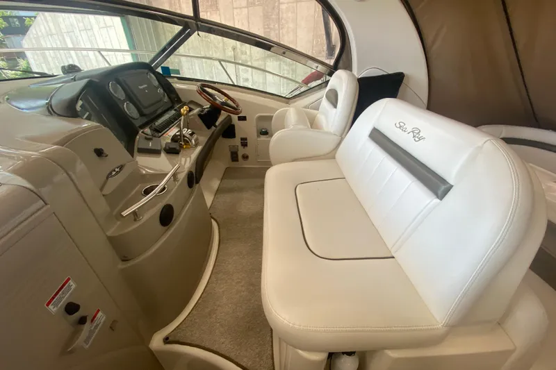 Slide: The Image of 2007 Sea Ray 40 Sundancer helm with white seating and modern controls. - 10