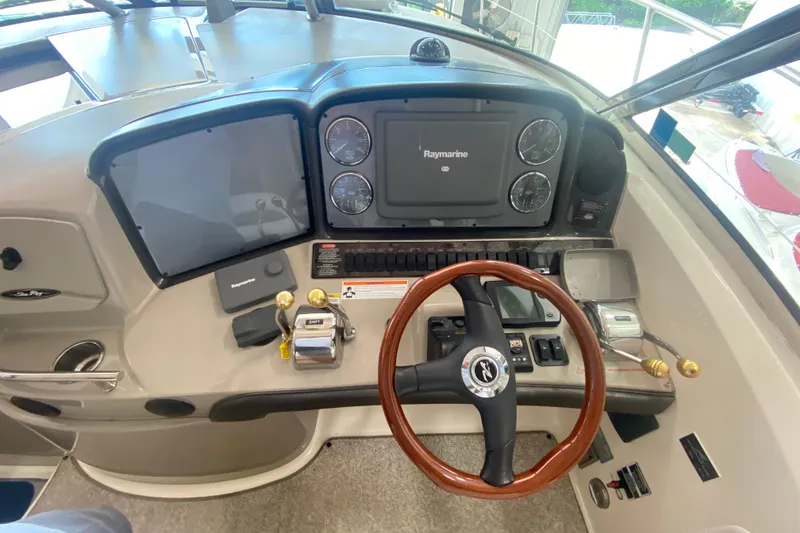 Slide: The Image of 2007 Sea Ray 40 Sundancer helm with Raymarine electronics and wooden steering wheel. - 11