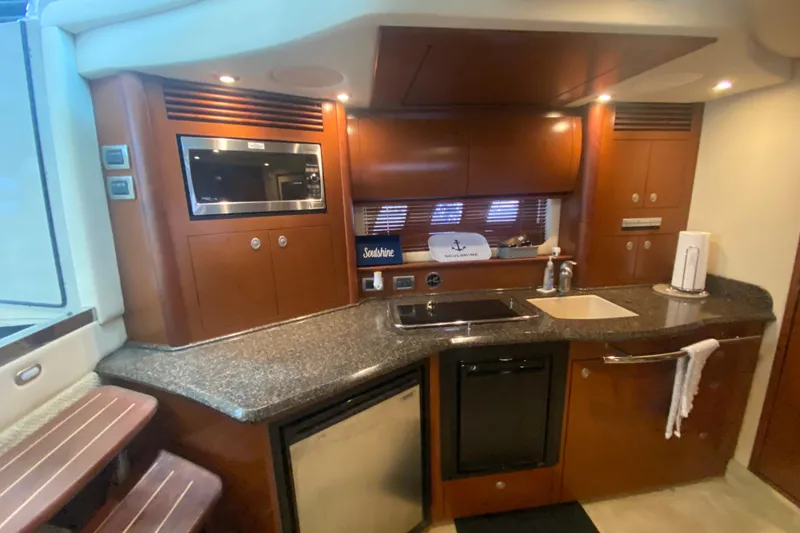 Slide: The Image of Luxurious 2007 Sea Ray 40 Sundancer yacht kitchen with modern amenities and sleek design. - 16