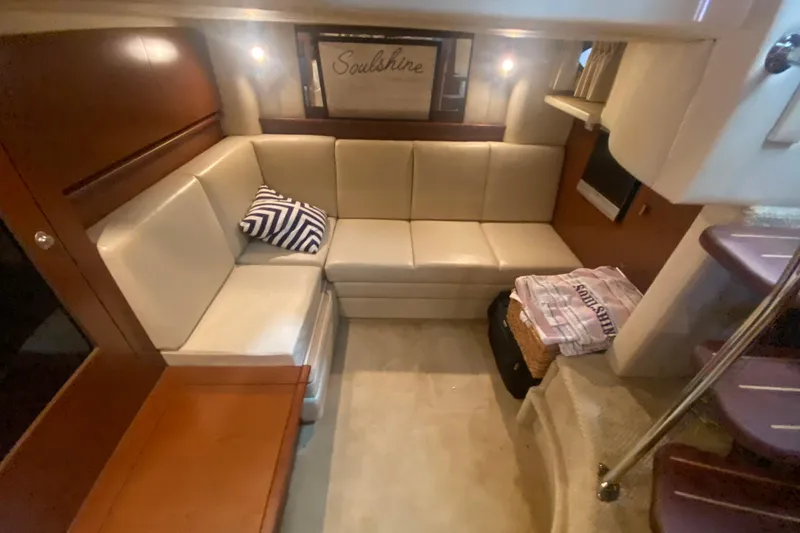 Slide: The Image of Luxurious interior of 2007 Sea Ray 40 Sundancer with beige seating and wooden accents. - 19