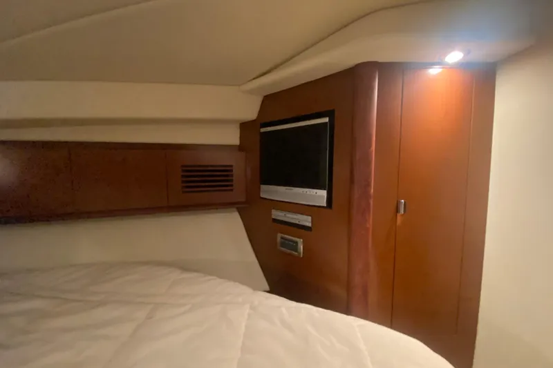 Slide: The Image of Interior cabin of 2007 Sea Ray 40 Sundancer with TV and wooden cabinetry. - 22