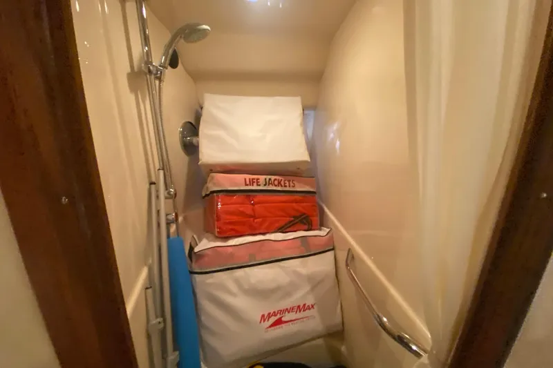 Slide: The Image of Storage area on 2007 Sea Ray 40 Sundancer with life jackets and marine equipment. - 24