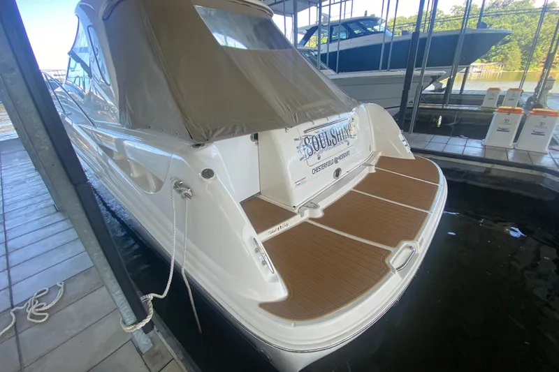 Slide: The Image of 2007 Sea Ray 40 Sundancer docked, featuring a covered deck and sleek design. - 3