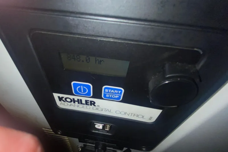 Slide: The Image of Kohler digital control panel displaying 848 hours on a 2007 Sea Ray 40 Sundancer. - 31