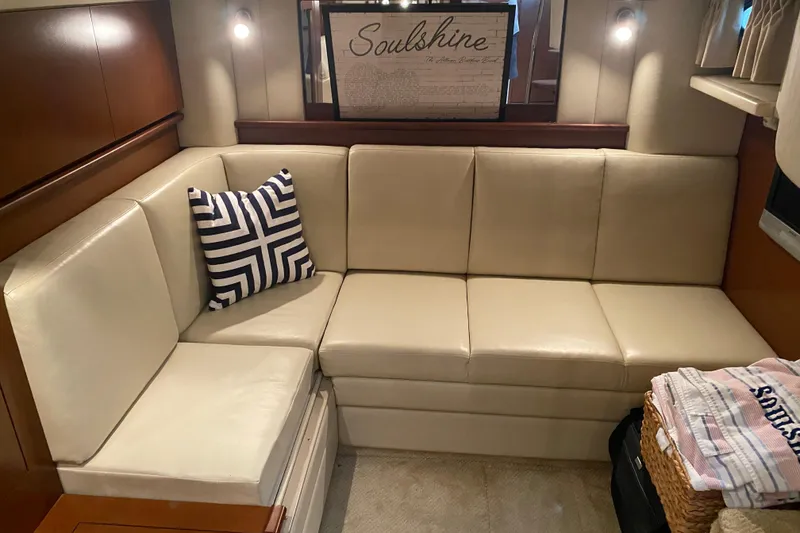 Slide: The Image of Luxurious interior of 2007 Sea Ray 40 Sundancer with cream leather seating and nautical decor. - 32