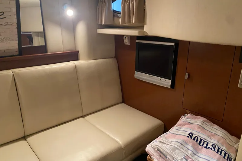 Slide: The Image of Interior of 2007 Sea Ray 40 Sundancer with beige seating and wall-mounted TV. - 33