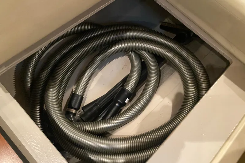 Slide: The Image of Coiled hose in storage compartment of 2007 Sea Ray 40 Sundancer boat. - 35