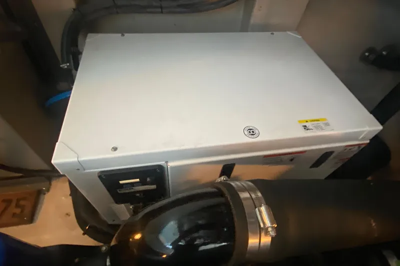 Slide: The Image of Engine compartment of a 2007 Sea Ray 40 Sundancer boat, featuring mechanical components. - 41
