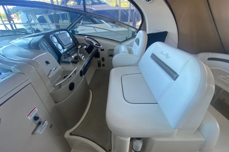 Slide: The Image of 2007 Sea Ray 40 Sundancer helm with white seating and modern controls. - 9