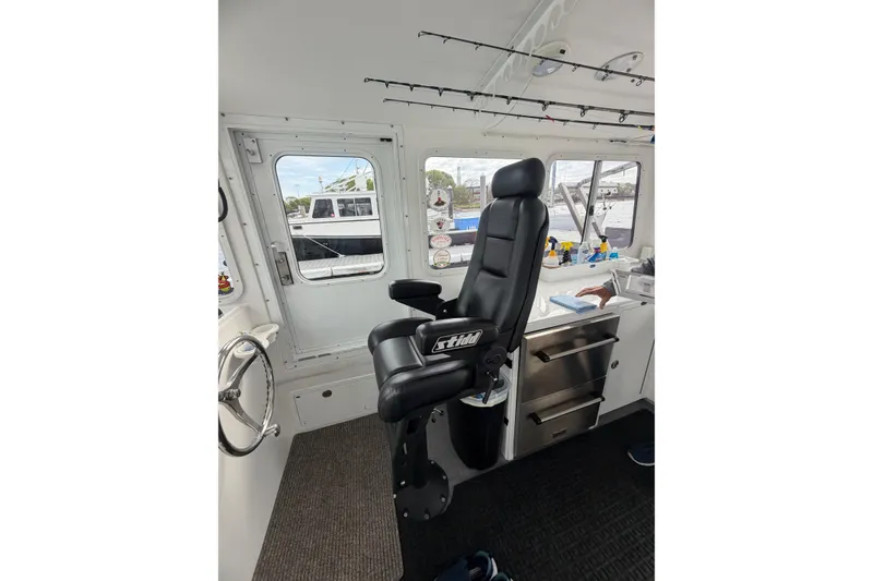 Slide: The Image of Interior of 2018 H&H Marine Osmond Beal boat with captain's chair and control panel. - 31