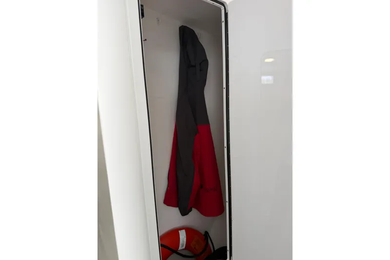 Slide: The Image of Coat hanging inside a 2018 H&H Marine Osmond Beal boat closet. - 54