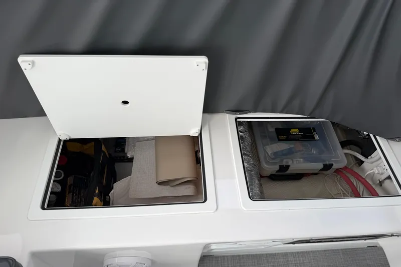 Slide: The Image of Storage compartments on a 2018 H&H Marine Osmond Beal boat, containing tools and equipment. - 25