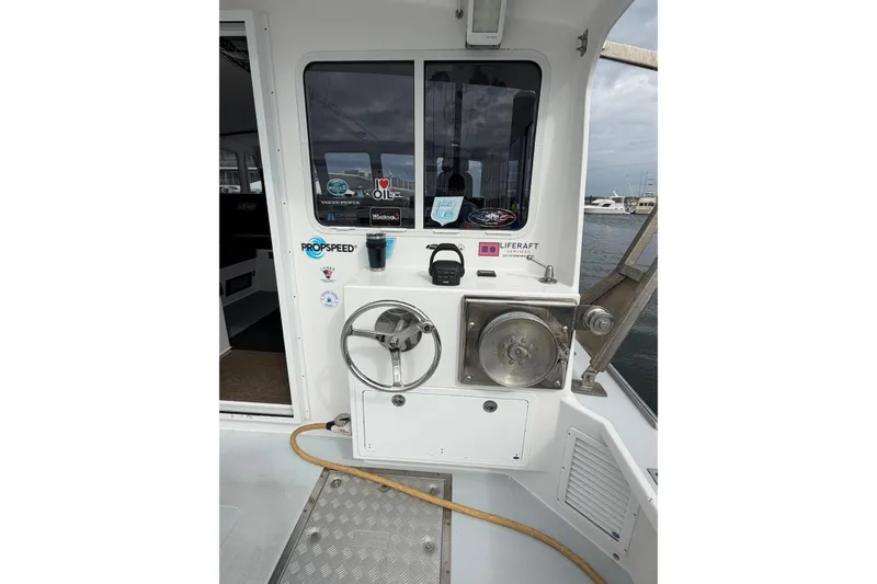 Slide: The Image of 2018 H&H Marine Osmond Beal boat helm with steering wheel and control panel. - 74