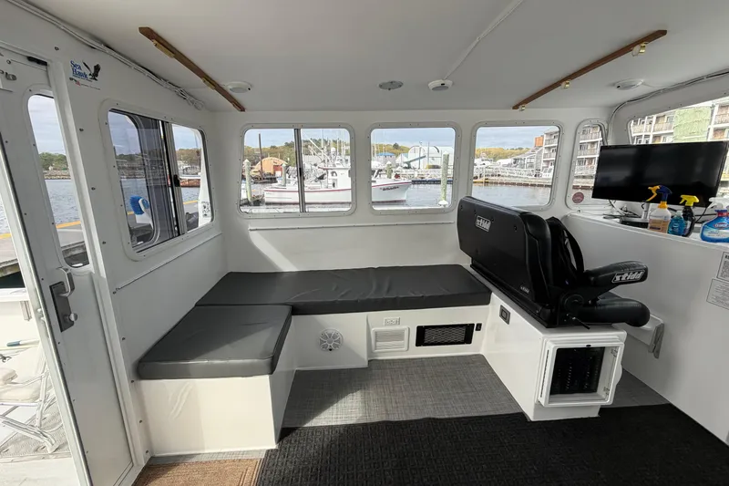Slide: The Image of Interior of 2018 H&H Marine Osmond Beal boat with seating and waterfront view. - 45