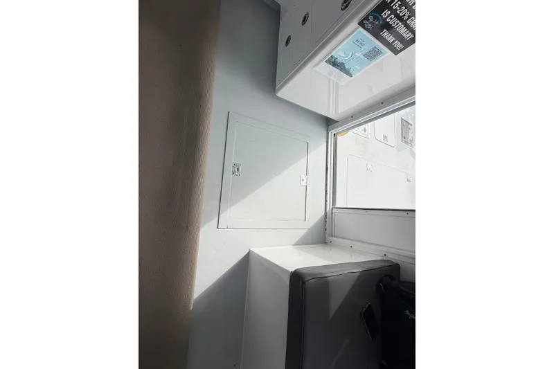 Slide: The Image of Interior of 2018 H&H Marine Osmond Beal boat, featuring seating and storage compartments. - 50