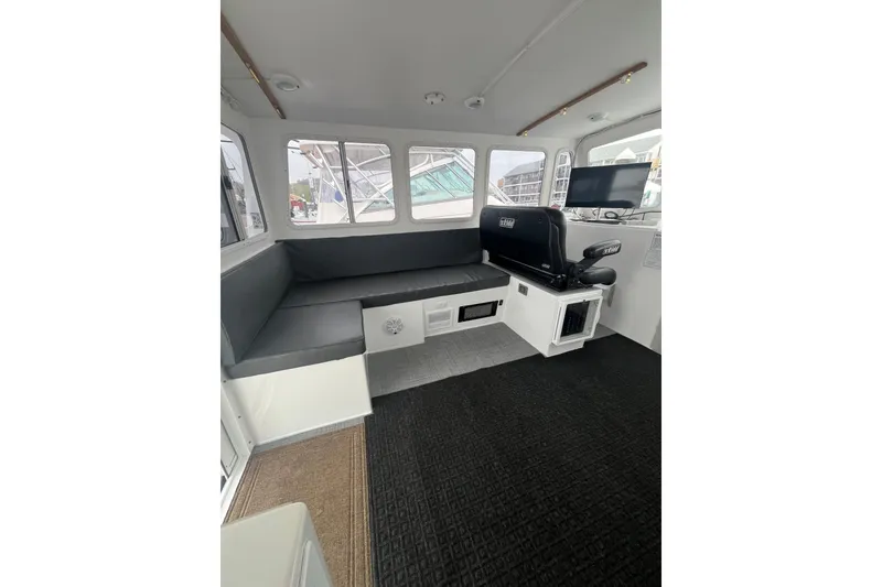 Slide: The Image of Interior of 2018 H&H Marine Osmond Beal boat with seating and navigation equipment. - 37