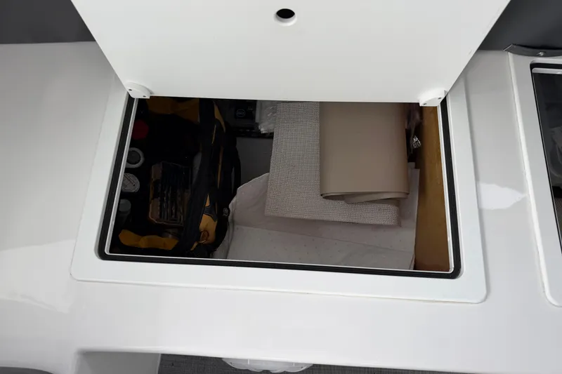 Slide: The Image of Storage compartment on a 2018 H&H Marine Osmond Beal boat, containing tools and materials. - 28
