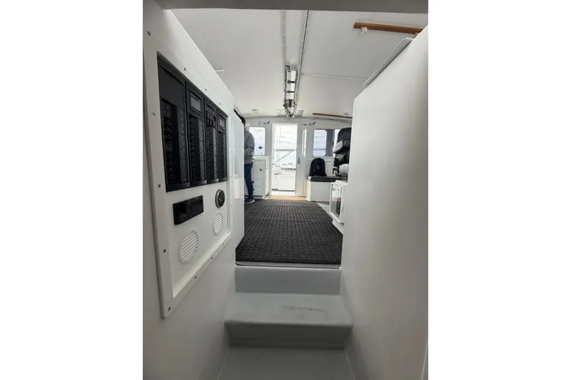 Slide: The Image of Interior view of 2018 H&H Marine Osmond Beal boat, featuring control panels and seating area. - 46