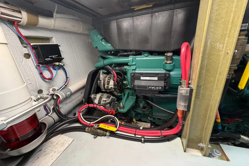 Slide: The Image of Engine compartment of a 2018 H&H Marine Osmond Beal boat, showcasing wiring and components. - 60