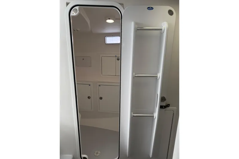 Slide: The Image of Interior of 2018 H&H Marine Osmond Beal boat, featuring storage compartments and sleek design. - 53