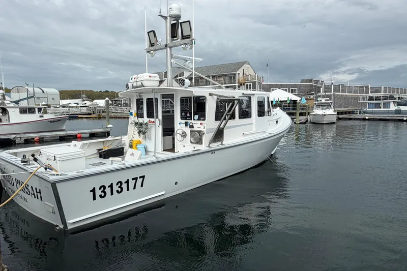 The Image of 2018 H&H Marine Osmond Beal boat docked in a marina under cloudy skies. - 0