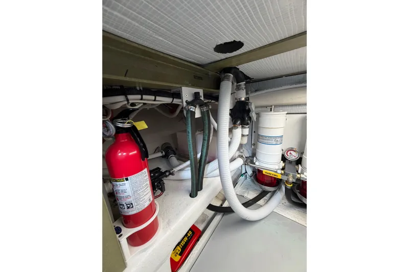 Slide: The Image of Engine compartment of 2018 H&H Marine Osmond Beal with fire extinguisher and hoses. - 57