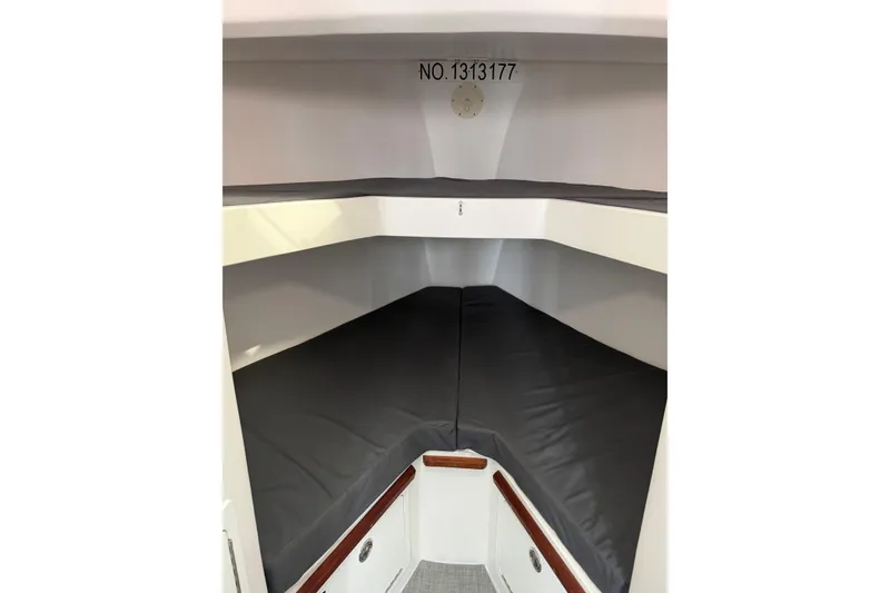 Slide: The Image of 2018 H&H Marine Osmond Beal cabin interior with gray cushions and storage compartments. - 49