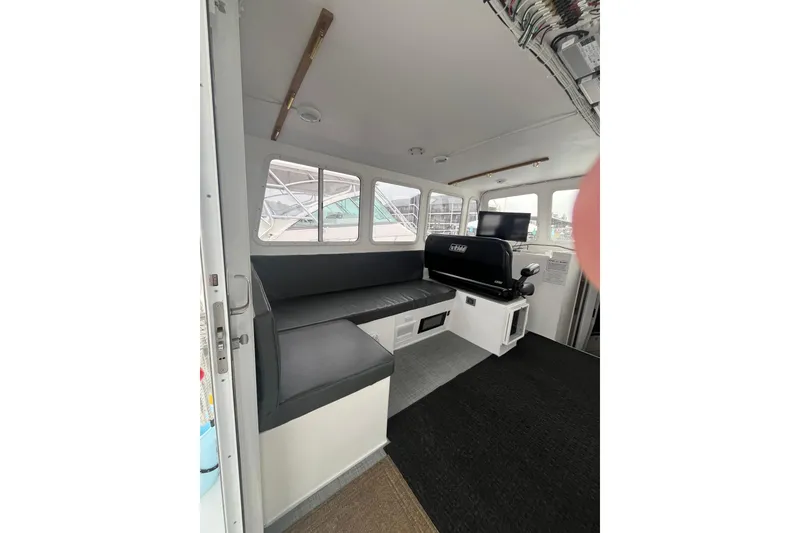 Slide: The Image of Interior of 2018 H&H Marine Osmond Beal boat with seating and windows. - 43