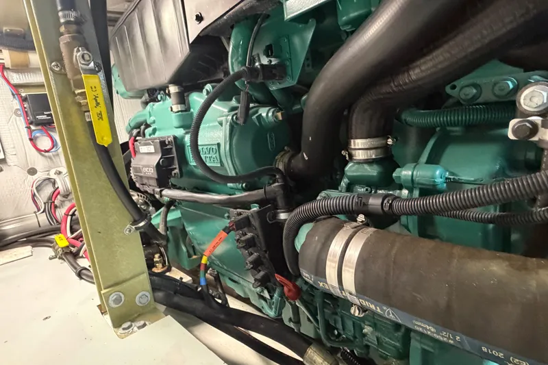 Slide: The Image of Engine compartment of a 2018 H&H Marine Osmond Beal boat, featuring Volvo Penta components. - 64
