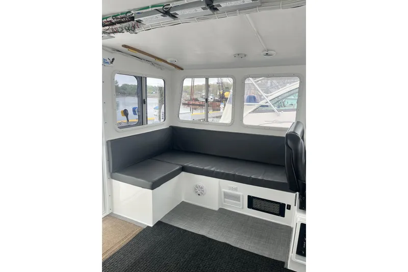Slide: The Image of Interior of 2018 H&H Marine Osmond Beal boat with seating and windows. - 39