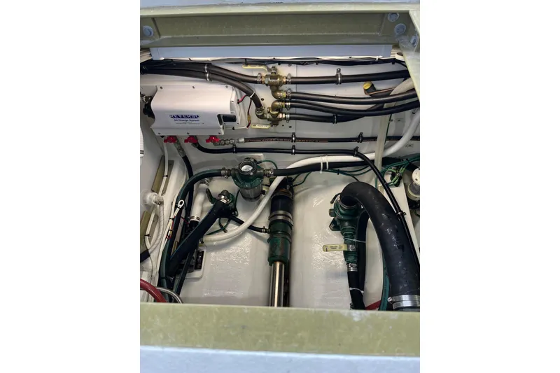 Slide: The Image of Engine compartment of 2018 H&H Marine Osmond Beal boat, showcasing mechanical components and wiring. - 96