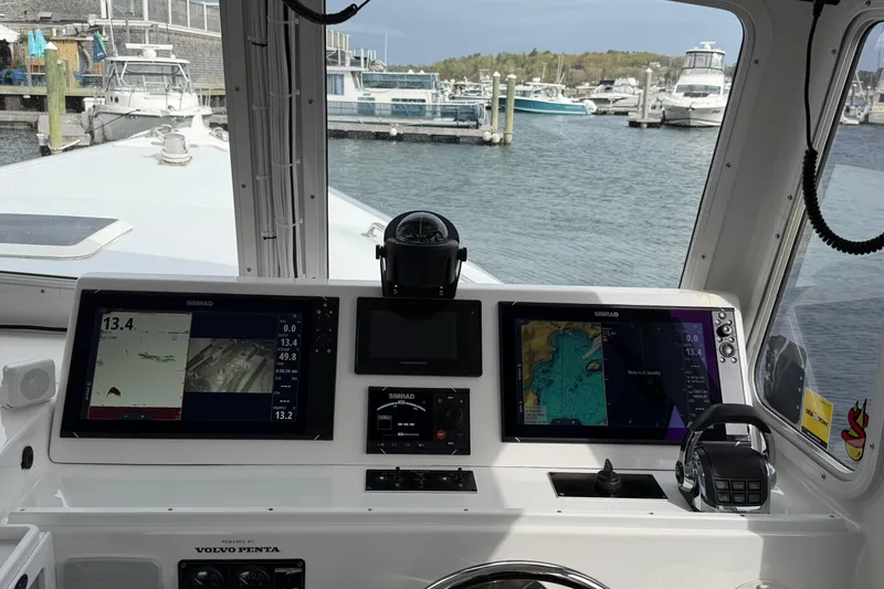 Slide: The Image of Helm of 2018 H&H Marine Osmond Beal boat with navigation screens in a marina. - 42
