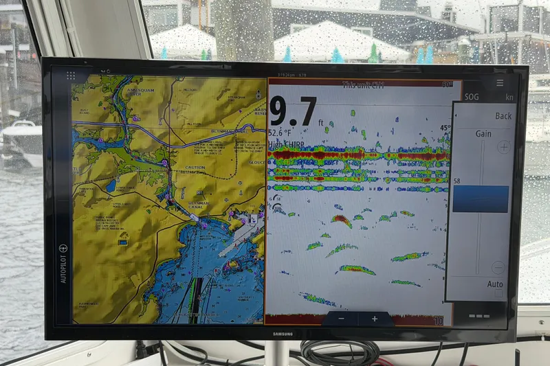 Slide: The Image of Boat navigation screen displaying map and sonar data on a rainy day. - 34