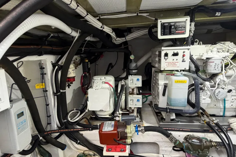 Slide: The Image of Engine room of a 2018 H&H Marine Osmond Beal boat, showcasing mechanical components and wiring. - 89